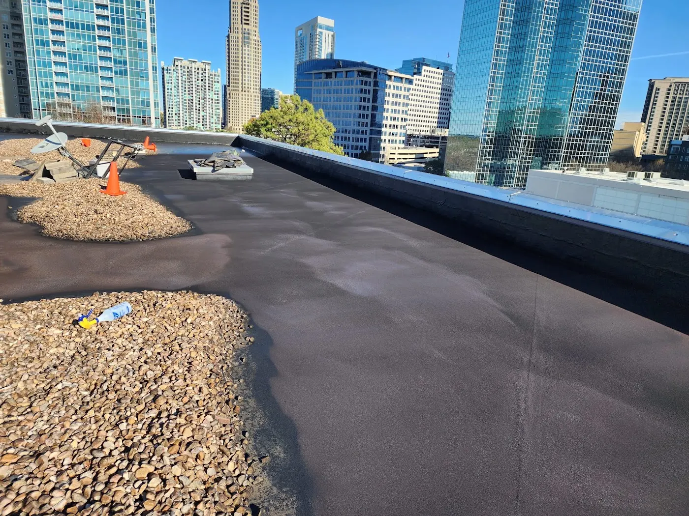 Wetsuit roof membrane around a rooftop curb, penetrations and parapet walls