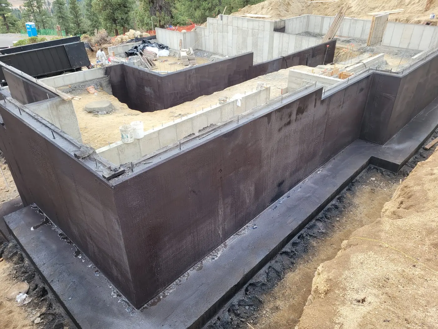 Concrete foundation walls coated in Wetsuit membrane