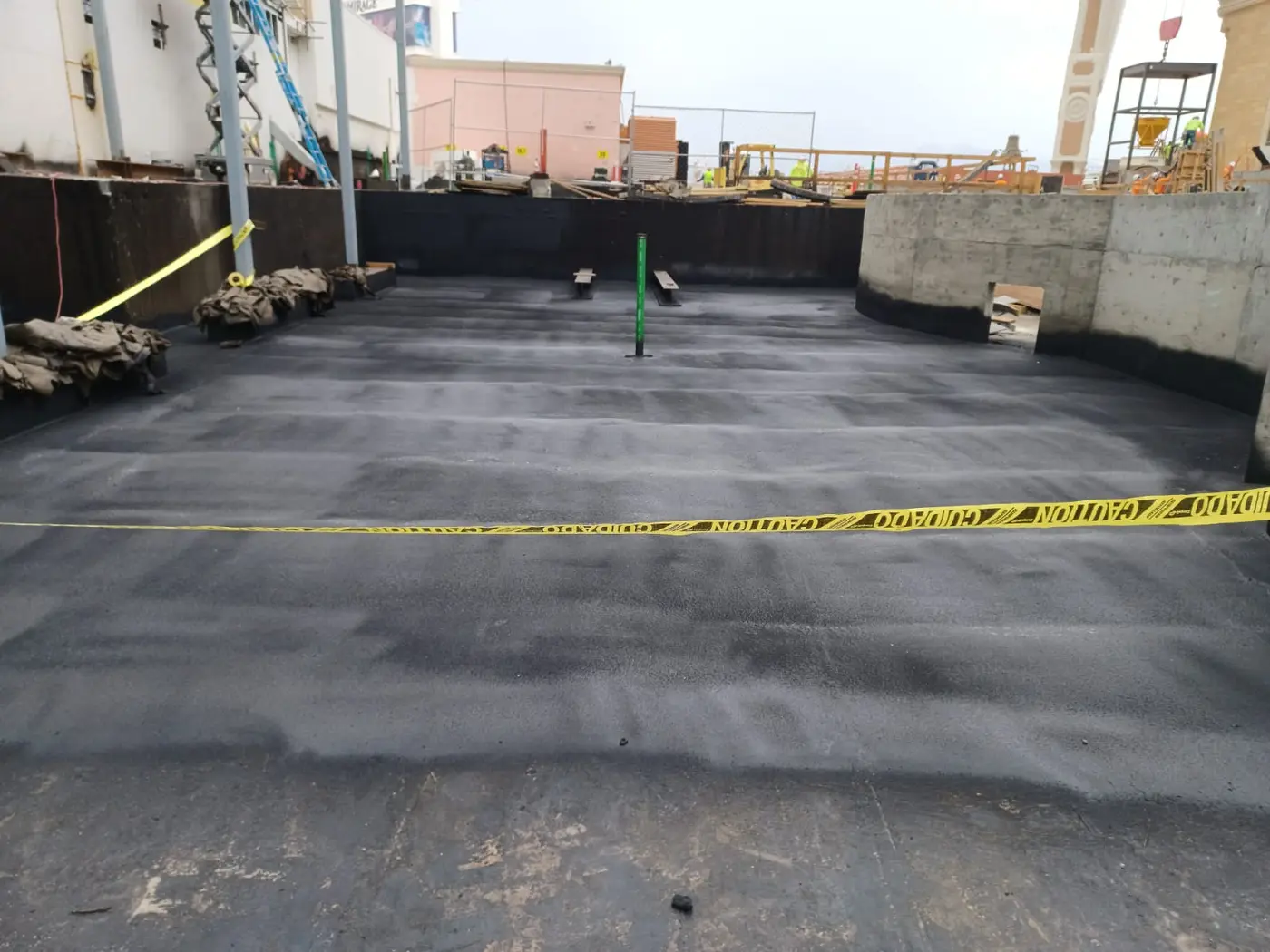Concrete slab and perimeter walls coated in black Wetsuit membrane
