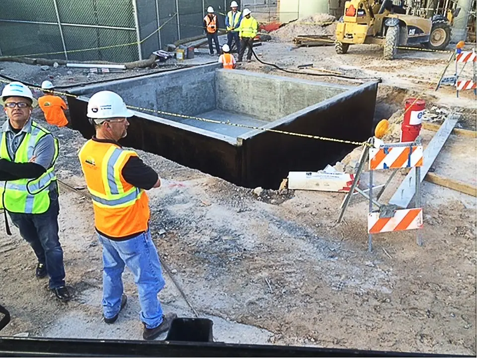 Inspectors at an elevator pit waterproofed with Wetsuit