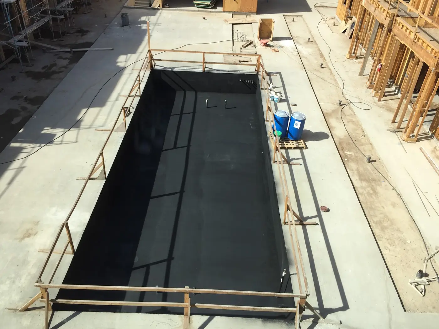 Large concrete pit lined with black Wetsuit membrane on a construction site